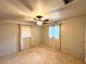 This bedroom features a ceiling fan, neutral carpet, and windows for natural light at 605 Wanamaker Ave, Fort Meade, FL 33841