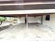 Carport featuring ceiling fans, support beams, concrete floor, and an entrance to the side door of the home at 605 Wanamaker Ave, Fort Meade, FL 33841