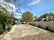 Long driveway with space for parking and a view of the home with partial fence at 605 Wanamaker Ave, Fort Meade, FL 33841