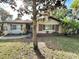 Charming single story home with a brick accent wall, mature trees, and a well-maintained front yard at 605 Wanamaker Ave, Fort Meade, FL 33841