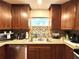 Bright kitchen featuring granite countertops, stainless steel appliances, and plentiful storage at 605 Wanamaker Ave, Fort Meade, FL 33841
