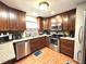 Well-equipped kitchen with stainless steel appliances, wood cabinets, and a window view at 605 Wanamaker Ave, Fort Meade, FL 33841