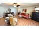 Cozy living room features stylish furniture, ceiling fan, and lots of natural light at 605 Wanamaker Ave, Fort Meade, FL 33841