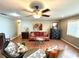 Comfortable living area with well-lit space, ceiling fan, and a variety of seating at 605 Wanamaker Ave, Fort Meade, FL 33841