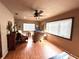 Inviting living room featuring neutral walls, wood flooring, a ceiling fan, and natural light at 605 Wanamaker Ave, Fort Meade, FL 33841