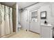 Small bathroom featuring tile floors, walk-in shower with white shower curtain, toilet, and sink at 608 William Ave, Winter Haven, FL 33880