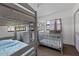 bedroom with a bunk bed, crib, and a view of the backyard at 608 William Ave, Winter Haven, FL 33880