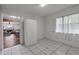 Bright bedroom with tile flooring, natural light, and a view of the living room at 608 William Ave, Winter Haven, FL 33880