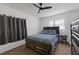 Cozy bedroom featuring a ceiling fan, dark wood furniture, and natural light at 608 William Ave, Winter Haven, FL 33880