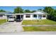Charming single-story home featuring a carport and well-maintained front lawn at 608 William Ave, Winter Haven, FL 33880