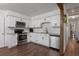Bright kitchen with white cabinetry, granite countertops, and stainless steel appliances at 608 William Ave, Winter Haven, FL 33880