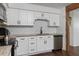 Updated kitchen with white cabinets, granite countertops, and stainless steel dishwasher at 608 William Ave, Winter Haven, FL 33880