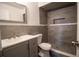 Modern bathroom featuring gray tiled shower and vanity with dual sinks at 612 Muskrat Dr, Kissimmee, FL 34759