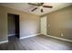 This bedroom features hard surface floors, ceiling fan, and a white door at 612 Muskrat Dr, Kissimmee, FL 34759