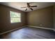 Neutral-toned bedroom features a window and ceiling fan for comfortable living at 612 Muskrat Dr, Kissimmee, FL 34759