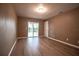 Bedroom with updated flooring, sliding glass door, and adjacent door at 612 Muskrat Dr, Kissimmee, FL 34759