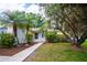 Welcoming front entrance with a walkway leading to a cozy home surrounded by mature landscaping at 612 Muskrat Dr, Kissimmee, FL 34759