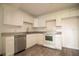 Bright kitchen features white cabinetry, stainless steel dishwasher, and a modern countertop at 612 Muskrat Dr, Kissimmee, FL 34759