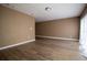 Open living room with wood-look flooring, neutral walls, and abundant natural light at 612 Muskrat Dr, Kissimmee, FL 34759