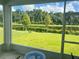 Relaxing screened-in back porch with a view of the lawn, trees, and lake at 6316 Dolostone Dr, Lakeland, FL 33811