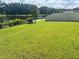 Lush backyard with a view of a lake and fence at 6316 Dolostone Dr, Lakeland, FL 33811