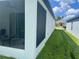View of the home's backyard with a screened lanai and adjacent green lawn at 6316 Dolostone Dr, Lakeland, FL 33811