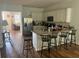 Open kitchen with granite countertops, stainless steel refrigerator, and breakfast bar seating at 6316 Dolostone Dr, Lakeland, FL 33811