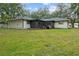 Lush backyard featuring a well-maintained lawn and mature trees creating a private oasis at 6320 Newman E Cir, Lakeland, FL 33811