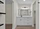 Updated bathroom with white cabinets, quartz counters, and modern light fixture at 6320 Newman E Cir, Lakeland, FL 33811