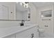 Updated bathroom with large countertop, white cabinets, and a modern black faucet and mirror at 6320 Newman E Cir, Lakeland, FL 33811