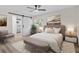 Modern bedroom featuring a barn door to the bathroom and light, neutral decor at 6320 Newman E Cir, Lakeland, FL 33811