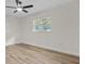 Bright bedroom showcases natural light through a window and updated flooring and paint at 6320 Newman E Cir, Lakeland, FL 33811