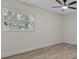 Bedroom showcases natural light through a window and updated flooring and paint at 6320 Newman E Cir, Lakeland, FL 33811
