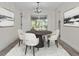 Dining area with round table, white chairs, modern light fixture, and outdoor views at 6320 Newman E Cir, Lakeland, FL 33811
