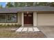 Close-up of house featuring a double door entry and two-car garage at 6320 Newman E Cir, Lakeland, FL 33811