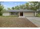 Charming single-story home with a two-car garage and beautifully maintained front yard at 6320 Newman E Cir, Lakeland, FL 33811