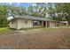A charming single-story home with a brick facade, lush lawn, and a spacious two-car garage at 6320 Newman E Cir, Lakeland, FL 33811