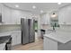Bright kitchen with white cabinets, quartz countertops, and stainless steel appliances at 6320 Newman E Cir, Lakeland, FL 33811