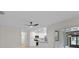 Open layout shows a white kitchen with stainless appliances, quartz counters and peninsula at 6320 Newman E Cir, Lakeland, FL 33811