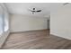 Spacious living room with wood floors, ceiling fan, and natural light at 6320 Newman E Cir, Lakeland, FL 33811
