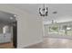 Living room featuring wood floors, modern lighting, and ample natural light at 6320 Newman E Cir, Lakeland, FL 33811
