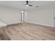 Spacious living room boasts modern ceiling fan, neutral paint, and wood-look flooring at 6320 Newman E Cir, Lakeland, FL 33811