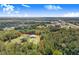The home is surrounded by trees and a sprawling landscape. Lot lines highlighted in red at 6344 Old Lake Wilson Rd, Davenport, FL 33896