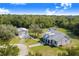 Aerial view of a home with a metal roof, adjacent to a detached garage and RV at 6344 Old Lake Wilson Rd, Davenport, FL 33896