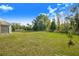 Lush backyard with a view of the home and a glimpse of an RV parked nearby at 6344 Old Lake Wilson Rd, Davenport, FL 33896