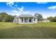 Backyard view of the house features large sliding doors with an entertainment area at 6344 Old Lake Wilson Rd, Davenport, FL 33896