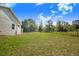 Expansive backyard featuring lush green grass and a glimpse of the home's exterior at 6344 Old Lake Wilson Rd, Davenport, FL 33896