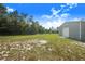 Spacious backyard with a new metal garage and plenty of room for outdoor activities at 6344 Old Lake Wilson Rd, Davenport, FL 33896