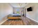 This large bedroom features bright light and hardwood floors at 6344 Old Lake Wilson Rd, Davenport, FL 33896