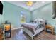Light bedroom with wood floors, neutral paint, and bright light at 6344 Old Lake Wilson Rd, Davenport, FL 33896